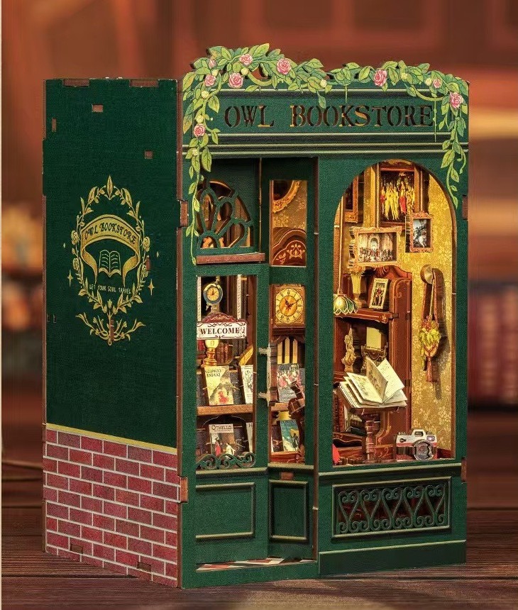 Owl Bookstore book nook with green storefront and glowing windows