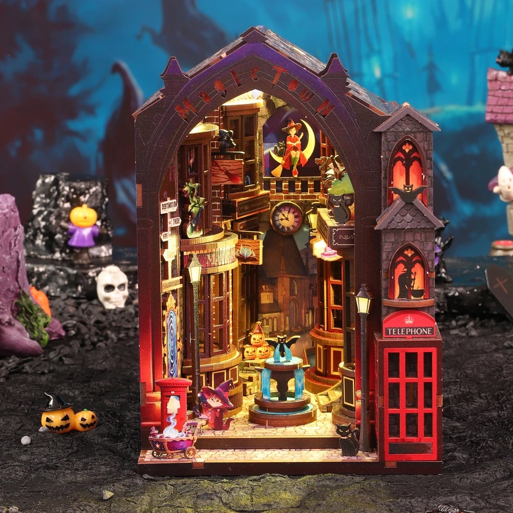 Assembled Magic Alley book nook glowing at night with lit shop windows, fountain and red telephone box